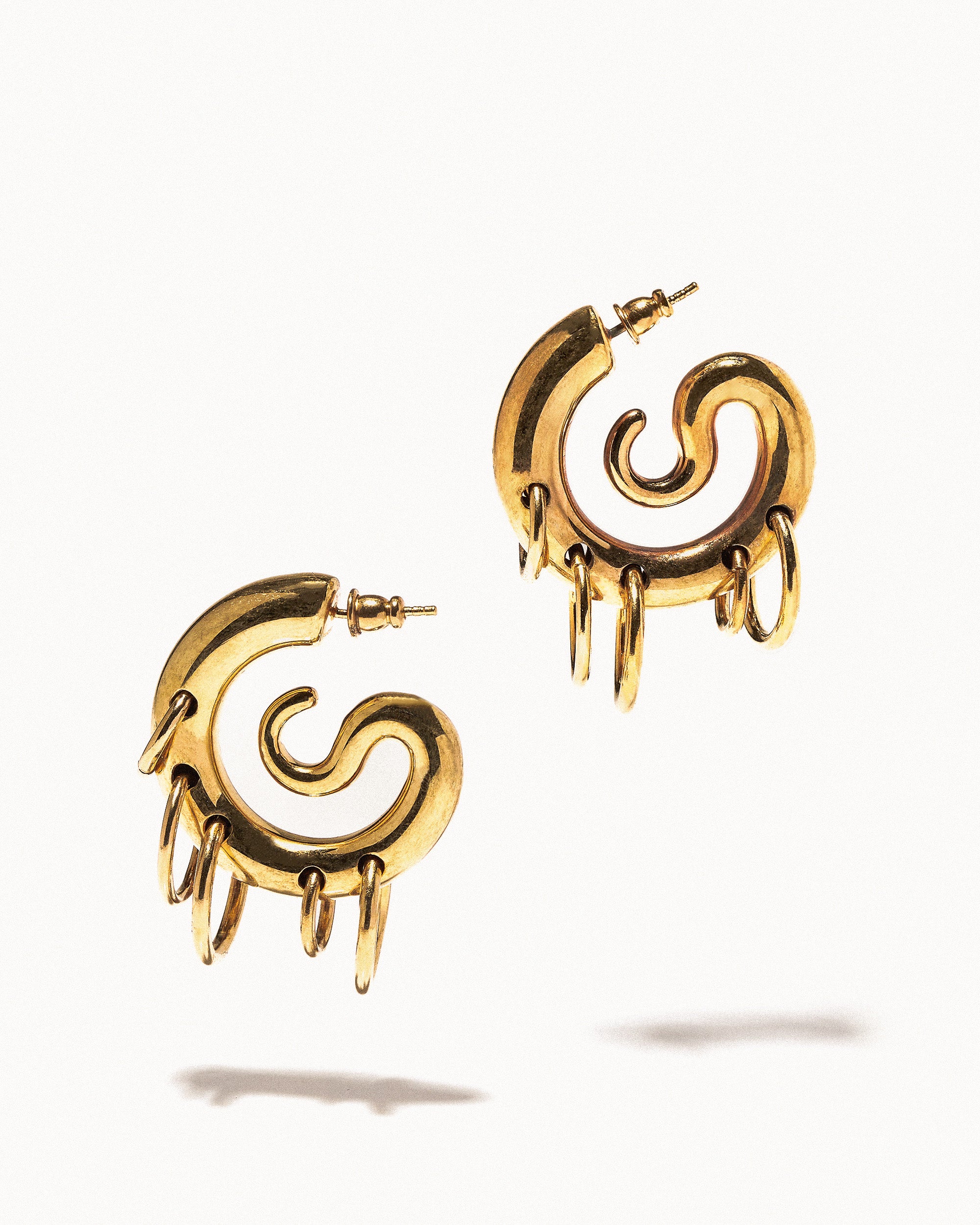 Pierced serpent hoops