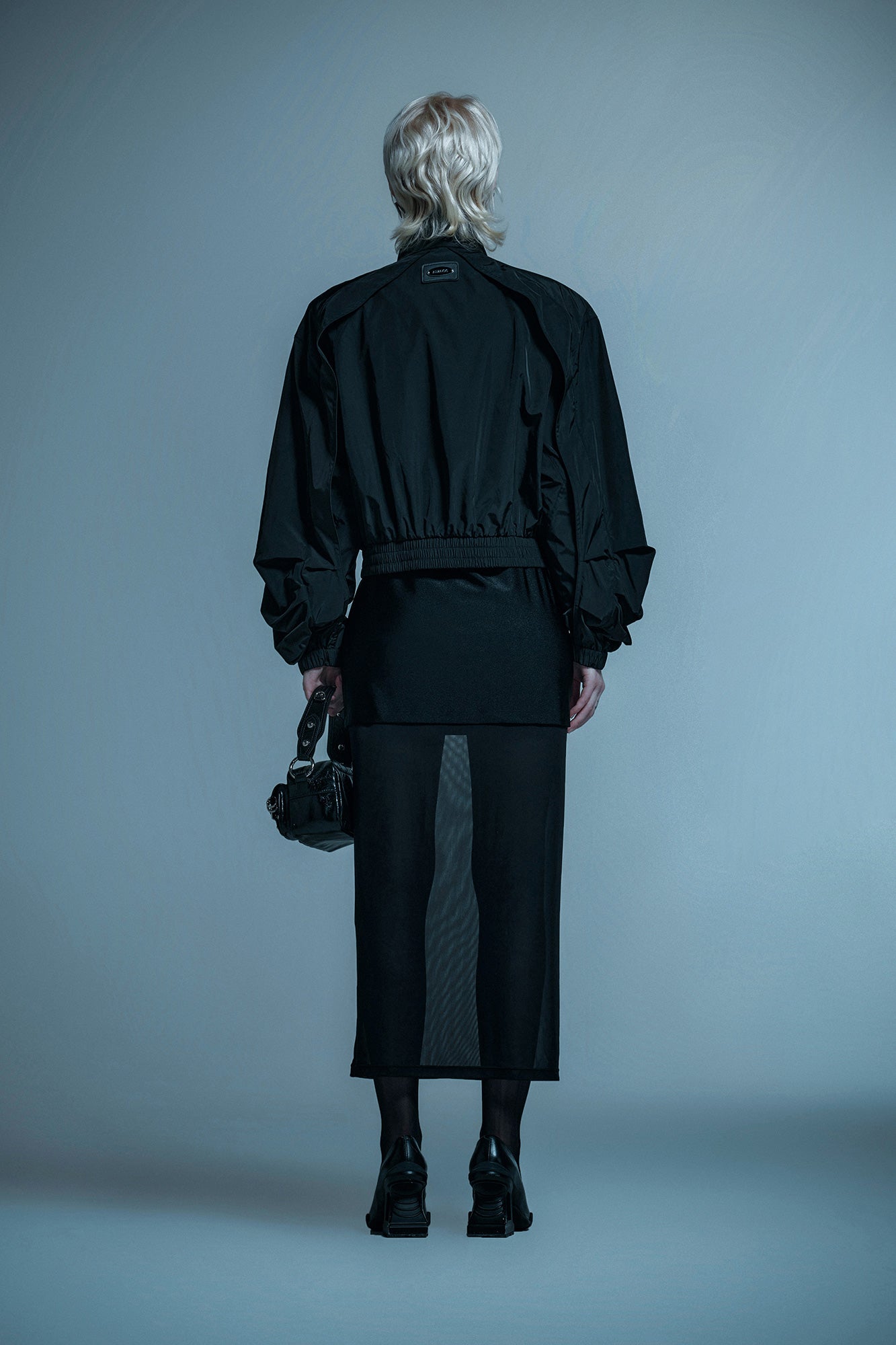Loose turtleneck coat with curved sleeves