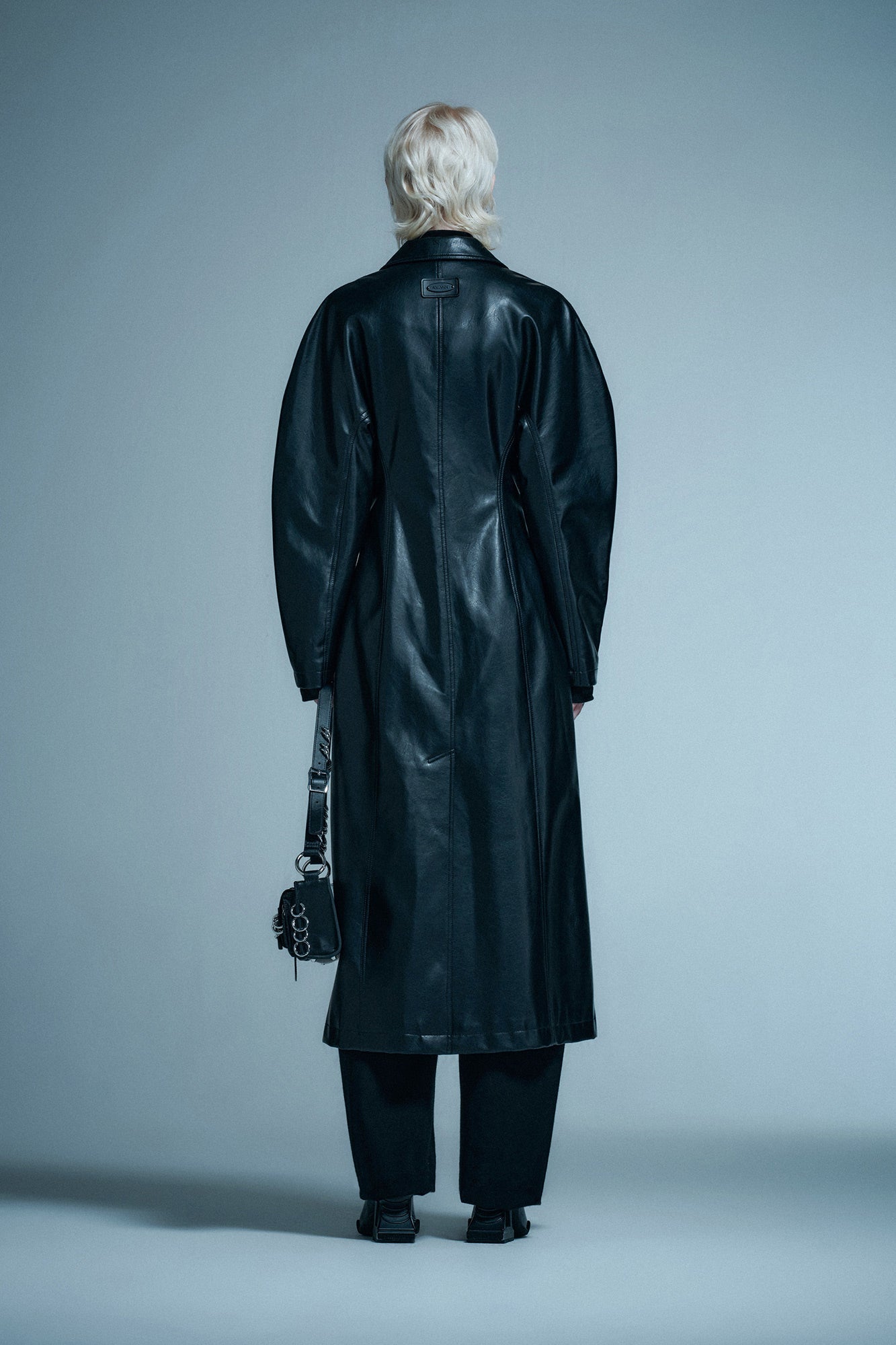 Long coat with curved sleeves and waist